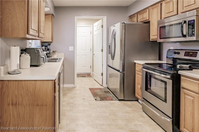 kitchen featuring light brown cabinets, sink, and appliances with stainless steel finishes