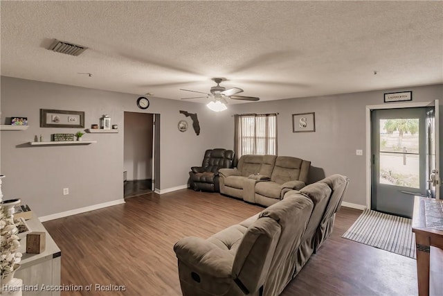 living room featuring ceiling fan, hardwood / wood-style floors, and a textured ceiling