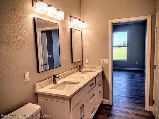 bathroom featuring hardwood / wood-style floors, vanity, and toilet