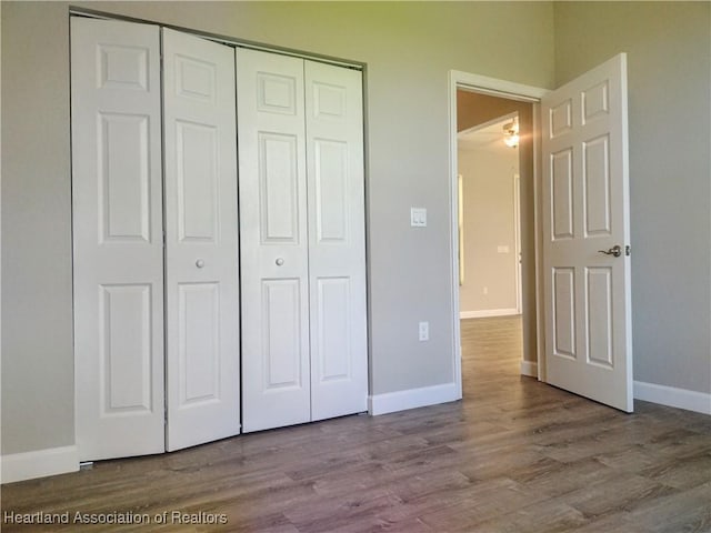 unfurnished bedroom featuring a closet and light hardwood / wood-style floors