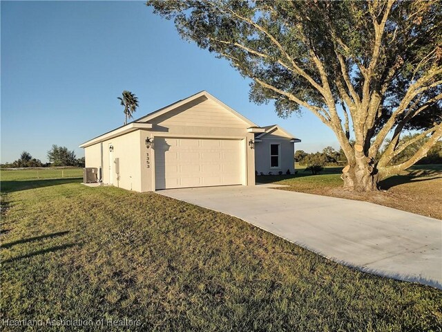 ranch-style home with central AC unit, a garage, and a front lawn