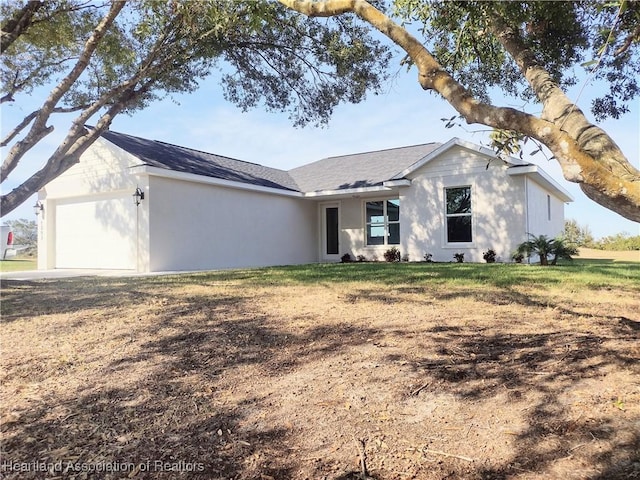 single story home featuring a front yard and a garage