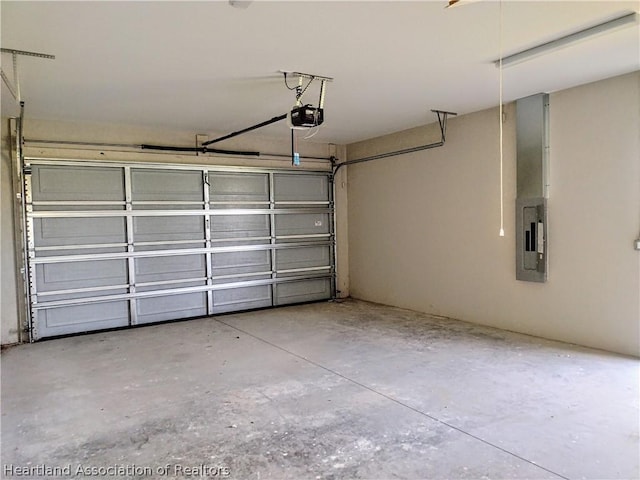 garage featuring electric panel and a garage door opener