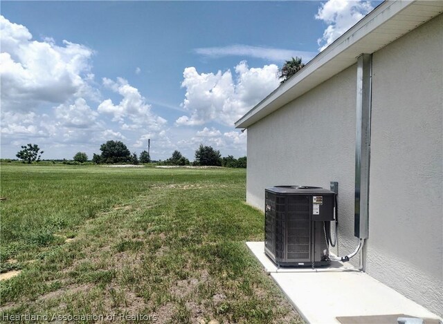 view of yard featuring cooling unit and a rural view