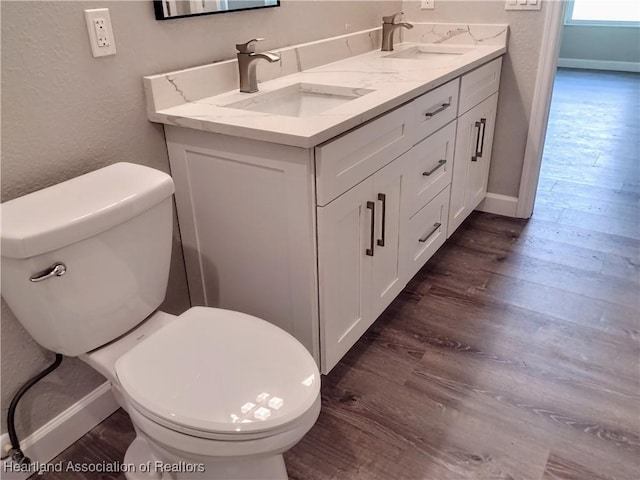 bathroom with vanity, wood-type flooring, and toilet