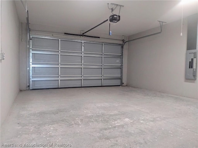 garage with electric panel and a garage door opener