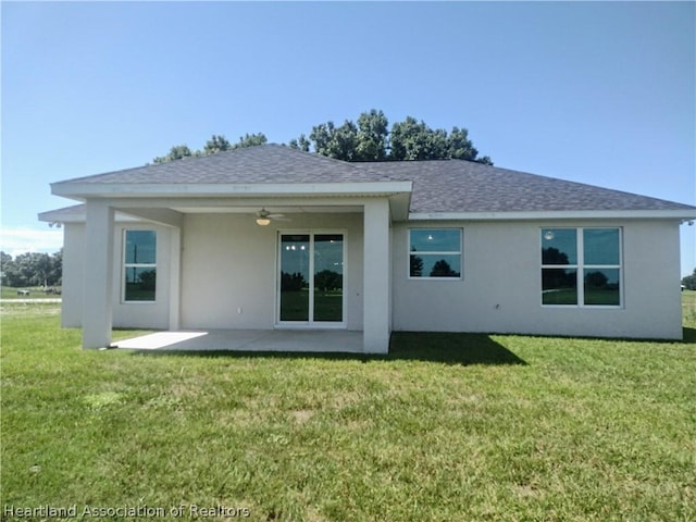 back of house featuring a patio, ceiling fan, and a lawn