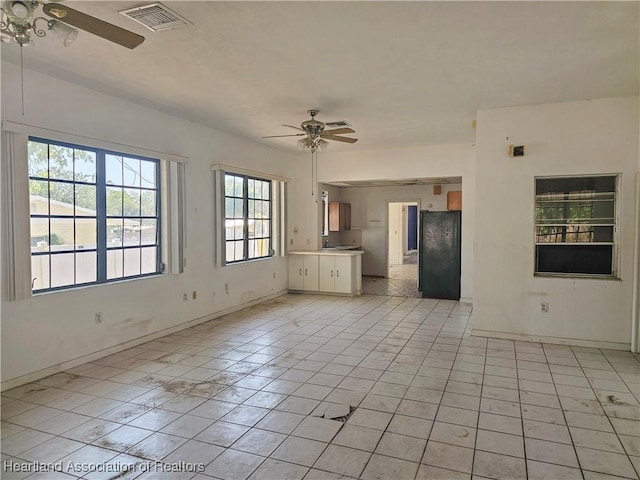 1237 Hitakee Ave, Sebring, FL 33870 - unfurnished living room with ceiling fan, light tile patterned floors, and baseboards