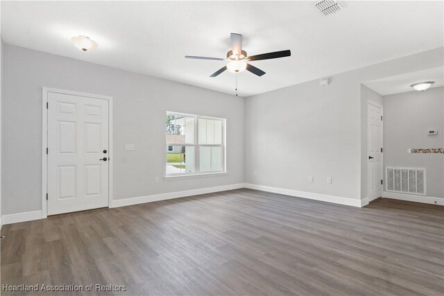 spare room with ceiling fan and dark hardwood / wood-style floors