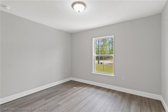 spare room with wood-type flooring