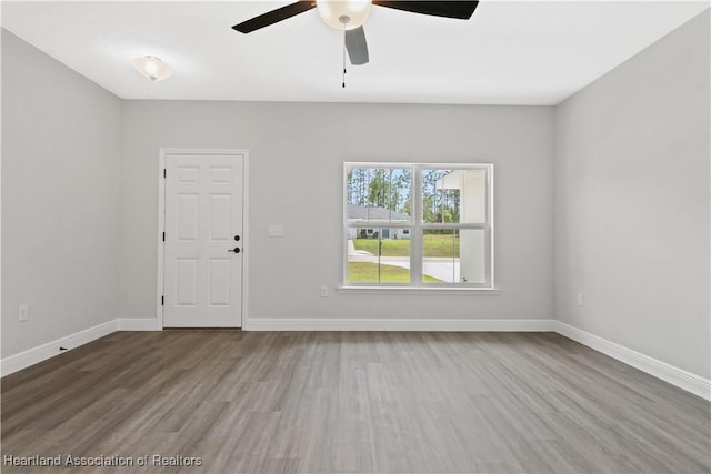 unfurnished room with ceiling fan and hardwood / wood-style flooring