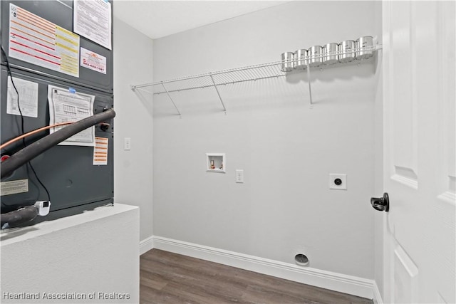 clothes washing area with electric dryer hookup, heating unit, washer hookup, and dark hardwood / wood-style floors