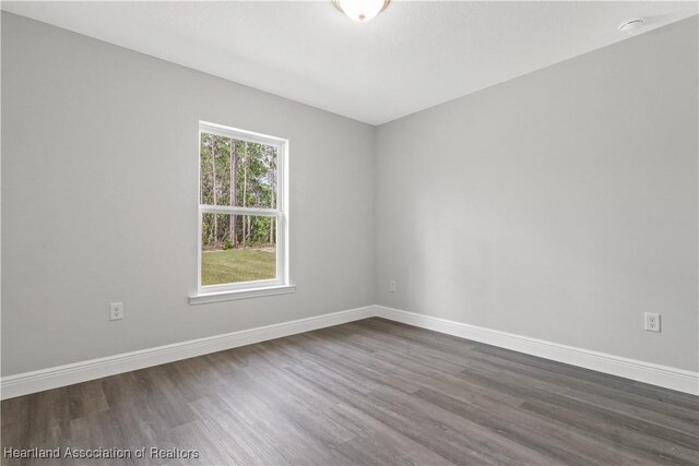 unfurnished room with hardwood / wood-style flooring