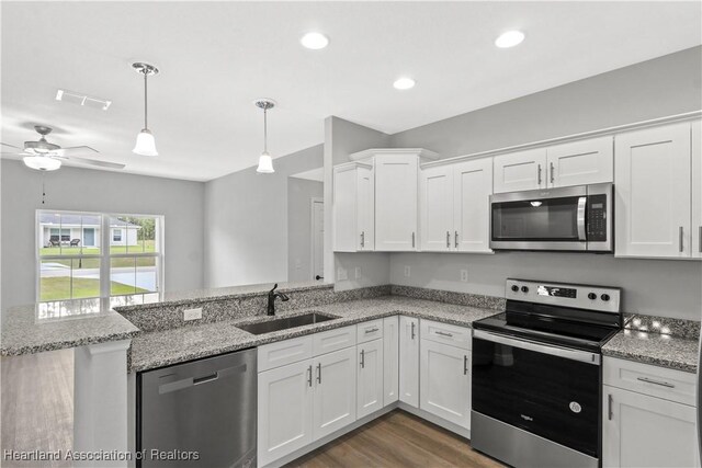 kitchen featuring sink, ceiling fan, decorative light fixtures, white cabinetry, and stainless steel appliances