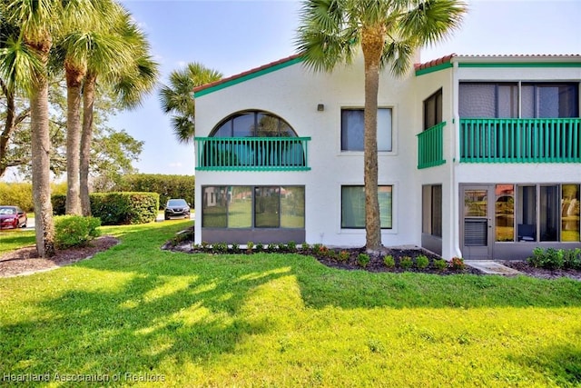 rear view of property with a yard