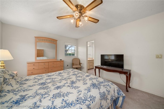 bedroom with a textured ceiling, ceiling fan, carpet floors, and ensuite bathroom