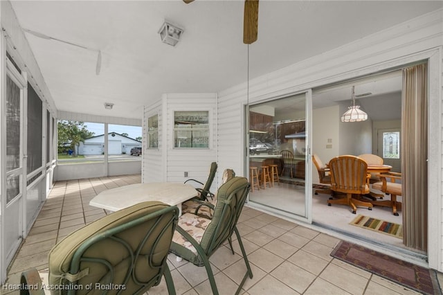 sunroom featuring a wealth of natural light and ceiling fan