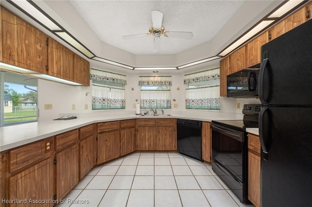 kitchen featuring black appliances, sink, ceiling fan, a textured ceiling, and light tile patterned flooring