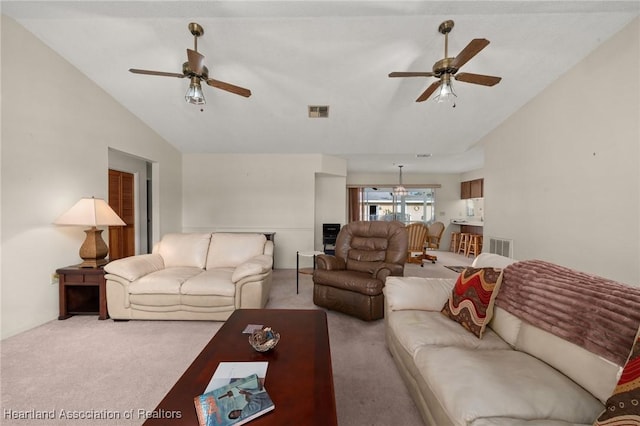 living room with ceiling fan, light colored carpet, and lofted ceiling