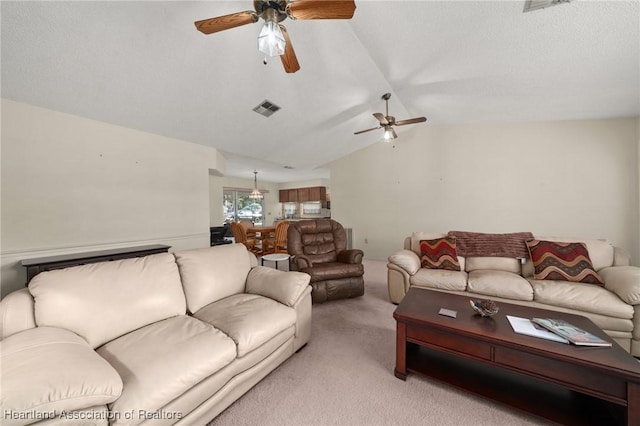 carpeted living room featuring lofted ceiling