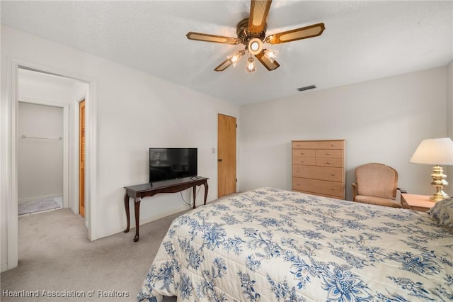 bedroom featuring ceiling fan and light colored carpet