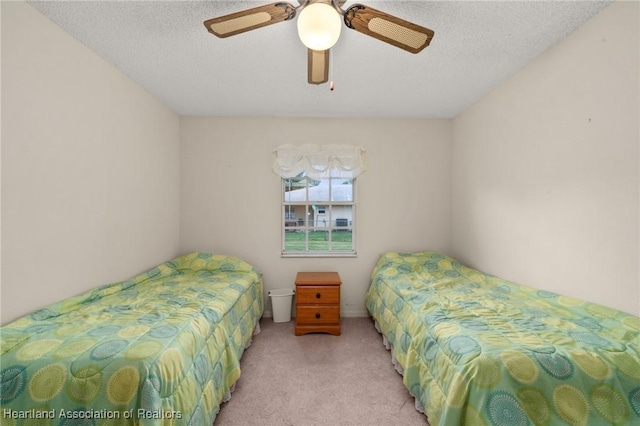 carpeted bedroom with a textured ceiling and ceiling fan