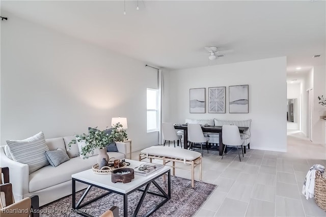 living room featuring visible vents and ceiling fan