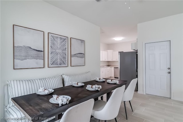 dining space featuring wood tiled floor