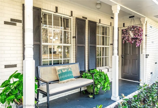 view of exterior entry featuring covered porch