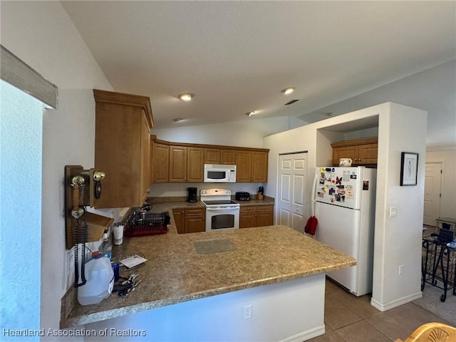 kitchen featuring kitchen peninsula, white appliances, vaulted ceiling, and light tile patterned flooring