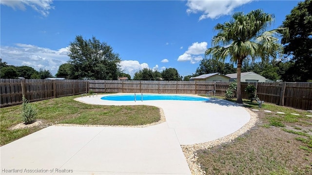 view of swimming pool featuring a yard and a patio