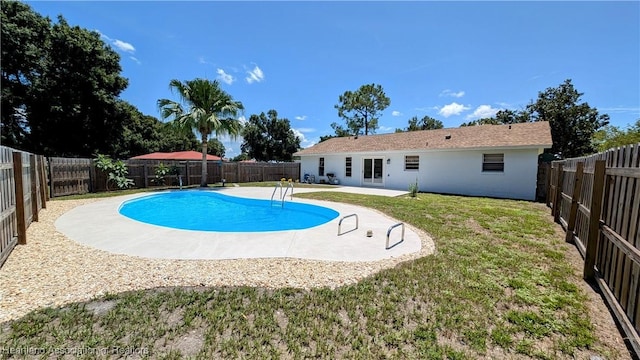 view of pool featuring a patio and a lawn