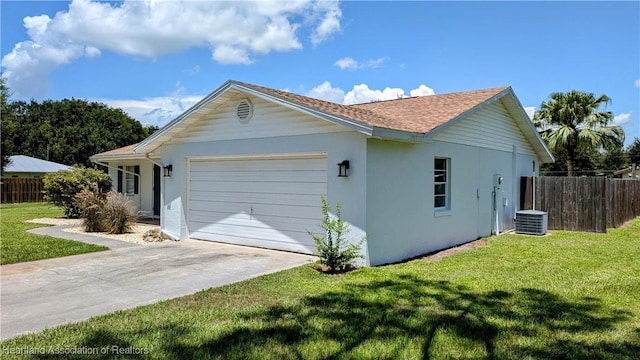 view of side of home with a yard and a garage