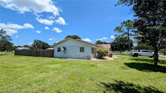 view of side of property with a yard