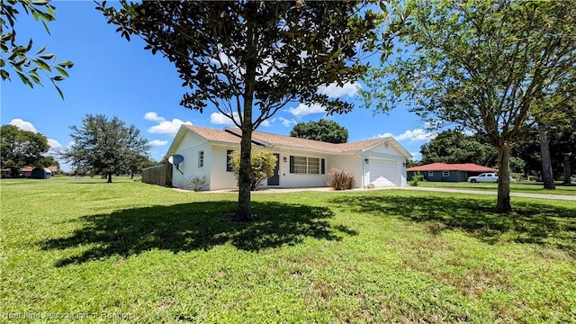 single story home featuring a garage and a front lawn