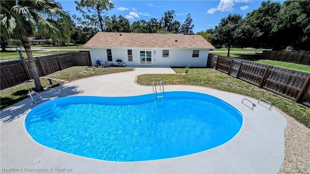 view of swimming pool with a lawn and a patio