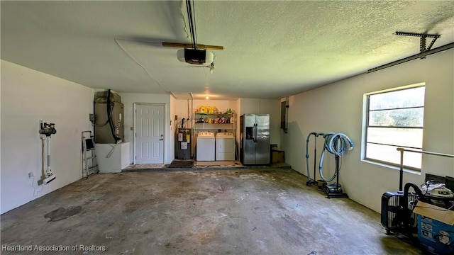 garage featuring stainless steel fridge, separate washer and dryer, a garage door opener, and water heater