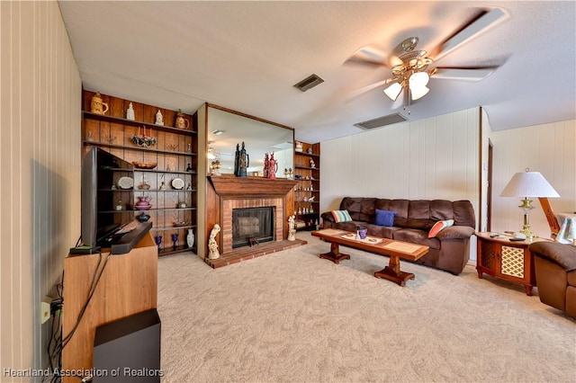 7700 Granada Rd, Sebring, FL 33876 - carpeted living area with a fireplace, built in features, visible vents, and a ceiling fan