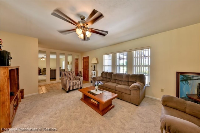 7700 Granada Rd, Sebring, FL 33876 - living area with light carpet, light tile patterned floors, baseboards, and a ceiling fan