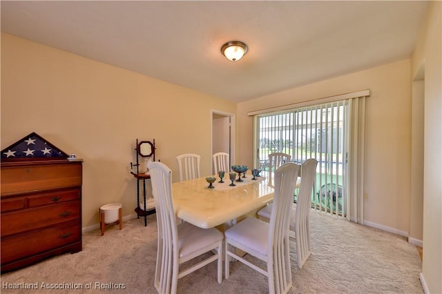 7700 Granada Rd, Sebring, FL 33876 - dining area with baseboards and light carpet