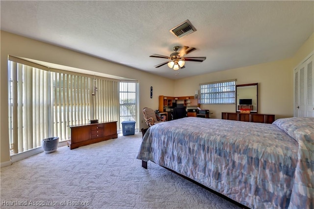 7700 Granada Rd, Sebring, FL 33876 - carpeted bedroom featuring a ceiling fan, visible vents, access to outside, and a textured ceiling
