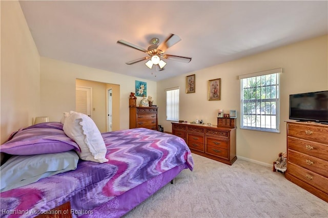 7700 Granada Rd, Sebring, FL 33876 - bedroom featuring light carpet, baseboards, and a ceiling fan