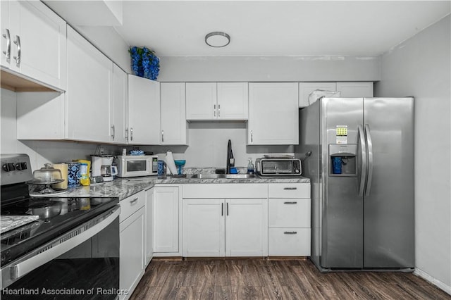 kitchen featuring sink, white cabinets, dark hardwood / wood-style floors, and appliances with stainless steel finishes