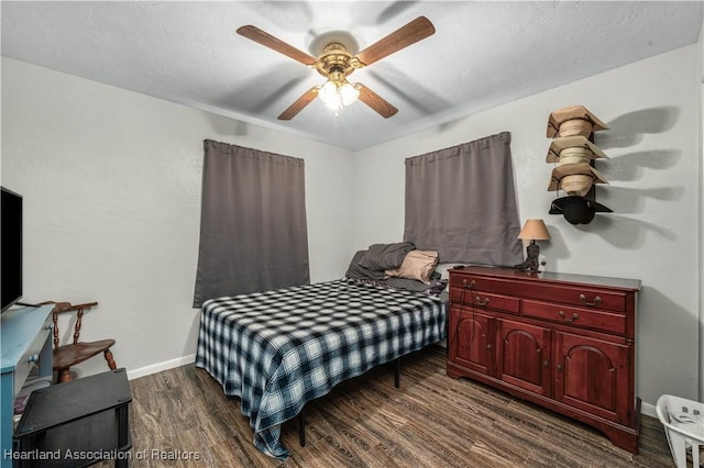 bedroom featuring ceiling fan and dark hardwood / wood-style flooring