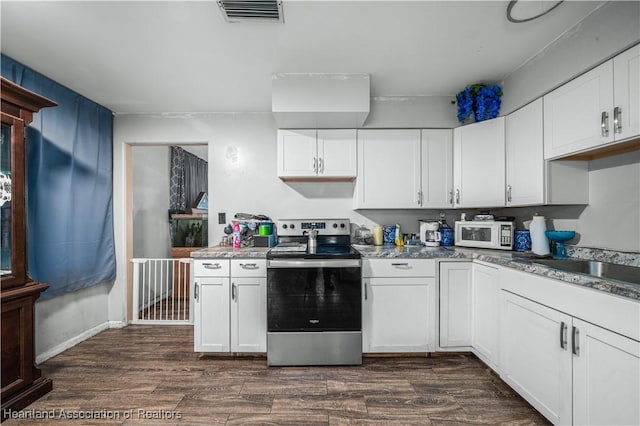 kitchen featuring dark hardwood / wood-style floors, white cabinetry, and stainless steel electric range