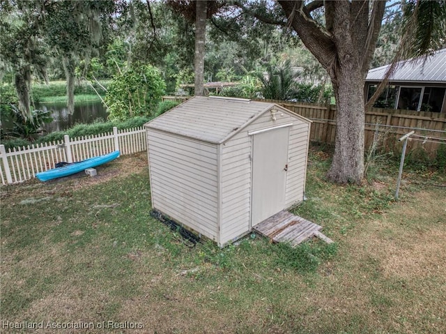 view of outdoor structure with a yard and a water view