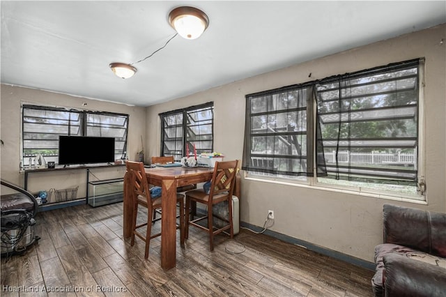 dining area featuring plenty of natural light and dark hardwood / wood-style floors