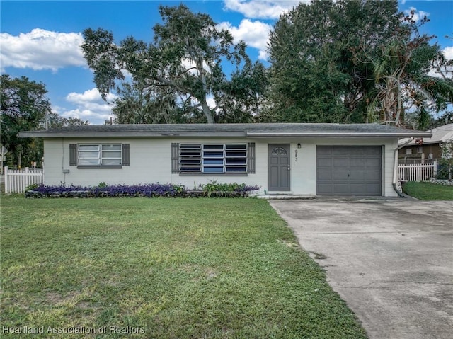 ranch-style home with a front yard and a garage