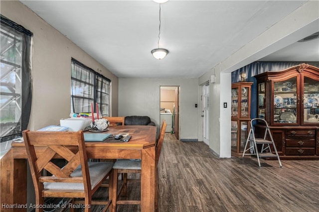 dining space featuring dark wood-type flooring and washer / clothes dryer