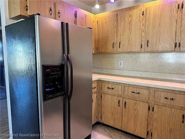 kitchen featuring backsplash and stainless steel fridge